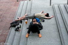 Queen Street Auckland city, sleeping it off on the library steps, photo by Mike Wheelton